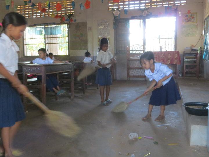 Kids cleaning the classroom before school                              